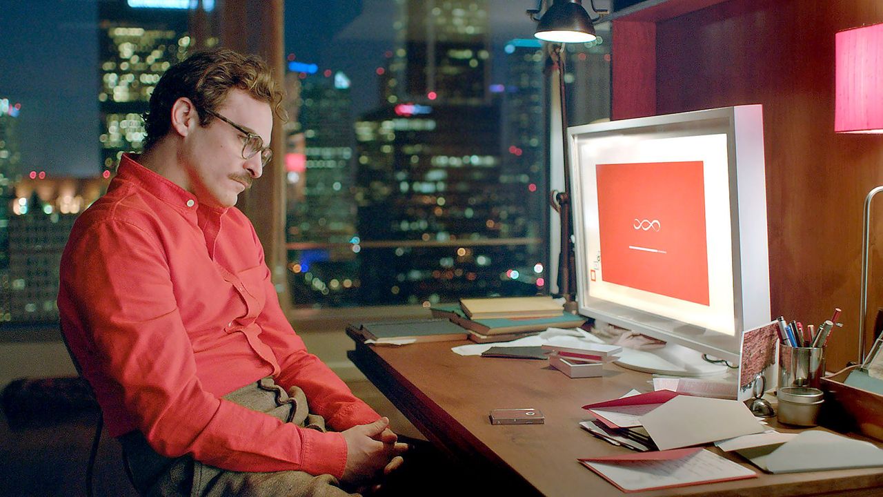 A still from the film Her: a man at his desk in conversation with his AI